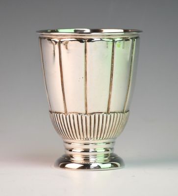 a silver vase that is sitting on a table