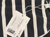 a black and white striped shirt with a tag on it