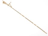 a close up of a long gold necklace with a cross on it