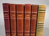 six vieux livres sont alignés sur une table