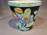 a close up of a flower pot on a table