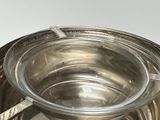 a metal bowl with a spoon in it on a table