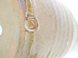 a close up of a vase with a ring on it