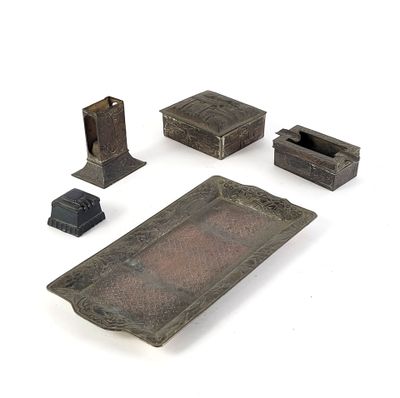 four pieces of metal that are sitting on a white surface