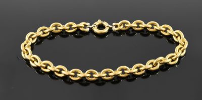 a gold chain bracelet on a black surface