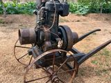 an old tractor that is sitting in the grass