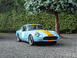 a blue and yellow sports car parked in a parking lot