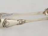 a pair of silverware spoons on a white surface
