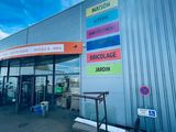the outside of a building with a lot of signs on the side of it