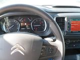 steering wheel of a car with dashboard controls and gauges