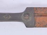a knife that is laying on a white surface