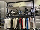 a picture of a clothing store with a lot of clothes on display