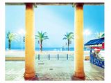 a view of a beach from a building with columns
