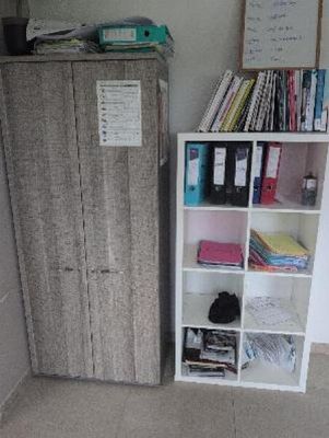 a bookcase and a cabinet in the corner of a room