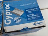 a box of staples on a table next to a pair of scissors