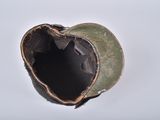 a broken helmet that is sitting on a table