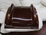 a white couch with a brown tray on top of it