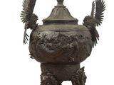 statue en bronze représentant deux oiseaux sur un socle, sur fond blanc