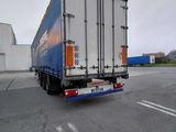 a semi truck that is driving down the street