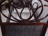 a wooden bed with a metal headboard and foot board