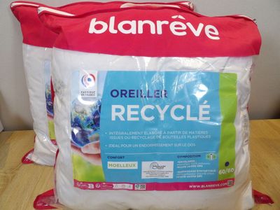 two bags of recycle sitting on a table