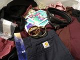 a pile of clothing and a pair of scissors on a bed