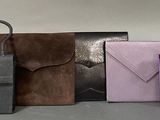 several different colored envelopes are lined up on a table