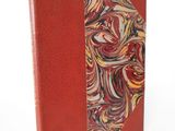 an image of a red book with a marbled design on it