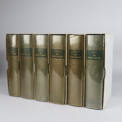 three books are lined up in a row on a white surface