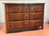 a wooden dresser with many drawers on top of it