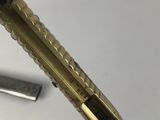 a pen that is sitting on a table next to a ruler