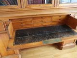 a wooden desk with a marble top in a room