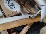 a box full of books and a baseball bat on the floor