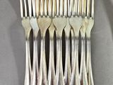 a lot of forks that are on a table