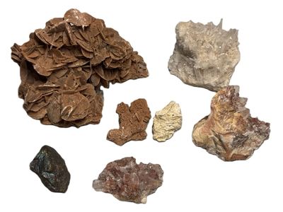 many different types of rocks on a white surface