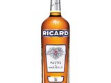 a bottle of ricard wine sitting on top of a white table