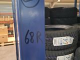 many tires stacked on a rack in a warehouse
