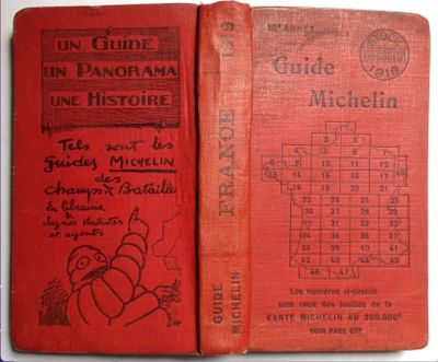 an old red book sitting on top of a table next to a calendar
