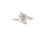 a close up of a diamond ring on a white surface