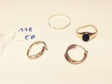 three rings and a ring with a blue stone on it