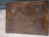 a small wooden box with a handle on the floor