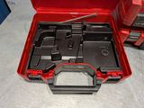 a red tool box with tools in it on a table