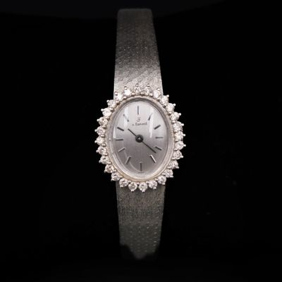 an image of a woman ' s wrist watch on a black background