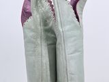 pair of white leather cowboy boots with pink trims on a white background