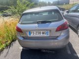 a silver car that is parked on the side of the road