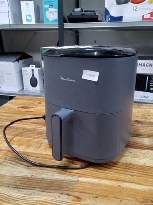a small air fryer sitting on a table in a kitchen