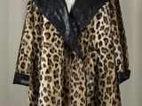 a woman ' s leopard print coat on a mannequin mannequin stand