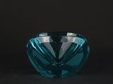 a close up of a blue glass bowl on a black background