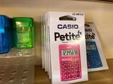 a pink calculator sitting on top of a counter