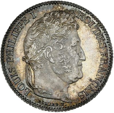 a silver coin with an image of a man ' s head on it